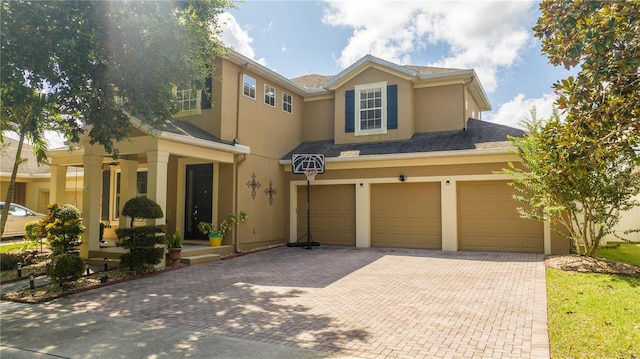 multi unit property featuring covered porch and a garage