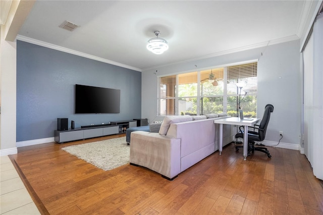 living room featuring hardwood / wood-style flooring and crown molding