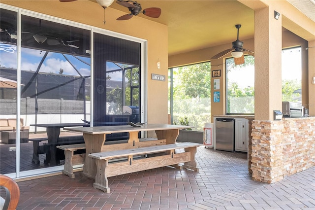 view of patio with a lanai and ceiling fan