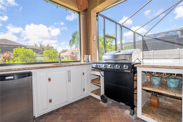 view of patio / terrace featuring a grill, sink, and a lanai