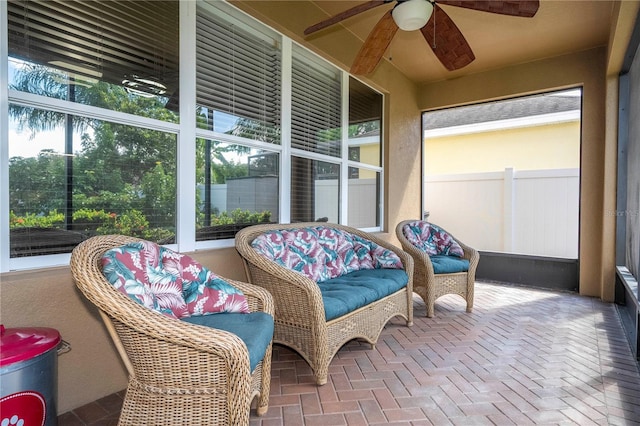 sunroom / solarium featuring ceiling fan