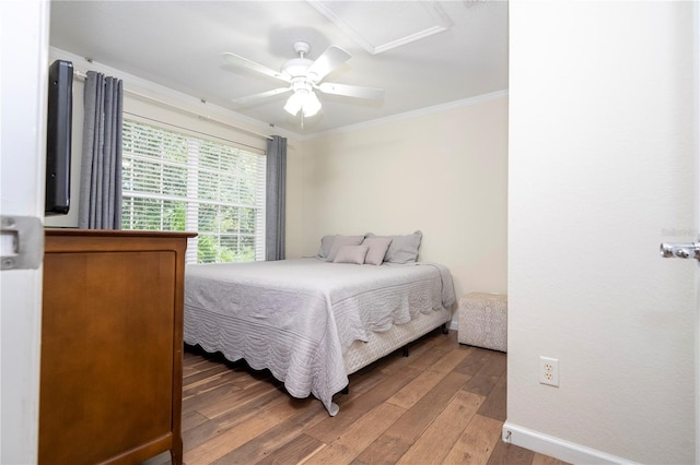 bedroom featuring wood-type flooring, crown molding, and ceiling fan