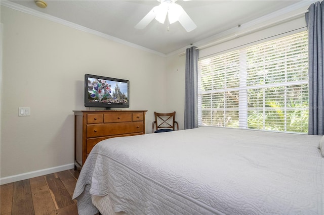 bedroom with ceiling fan, dark hardwood / wood-style floors, and ornamental molding