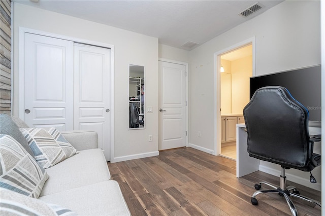 home office with dark wood-type flooring