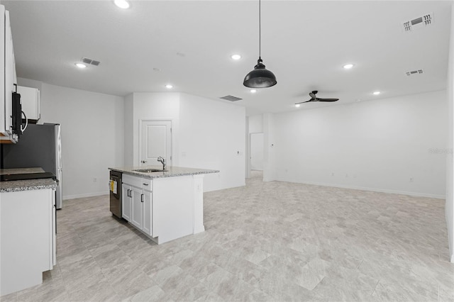 kitchen with decorative light fixtures, white cabinetry, sink, ceiling fan, and a kitchen island with sink