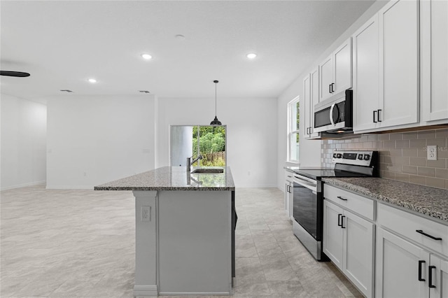 kitchen featuring a kitchen island with sink, white cabinetry, stainless steel appliances, and sink