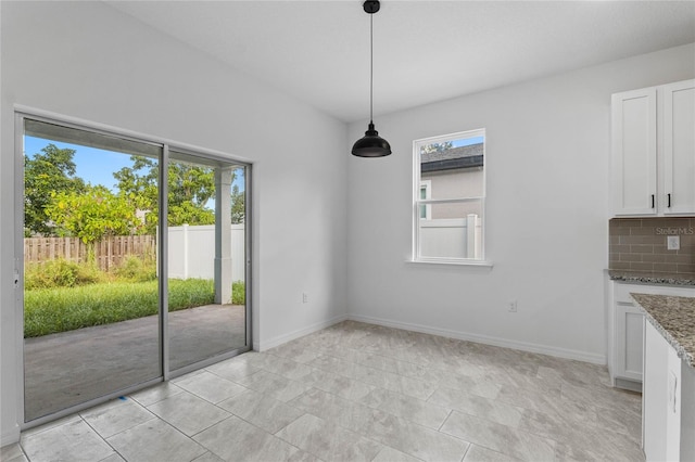 unfurnished dining area with a healthy amount of sunlight and light tile patterned flooring