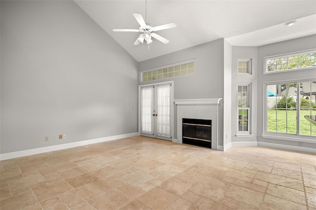 unfurnished living room with french doors, high vaulted ceiling, a wealth of natural light, and ceiling fan