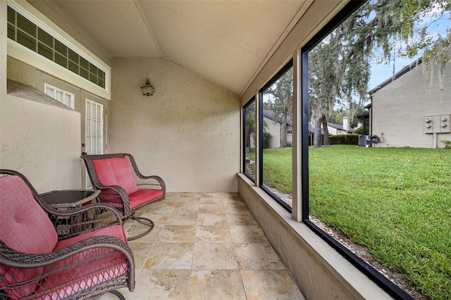 sunroom featuring vaulted ceiling