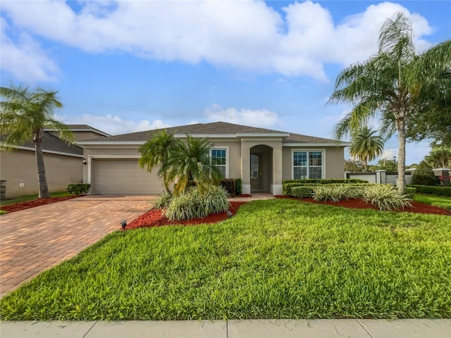 ranch-style house with a garage and a front lawn