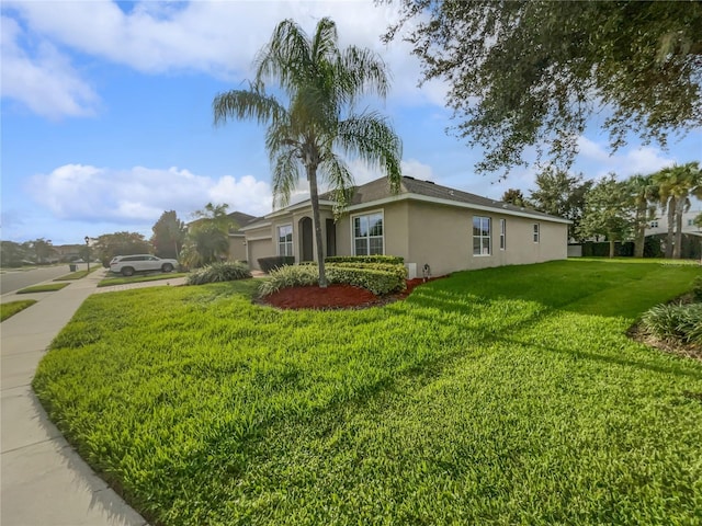 view of side of property featuring a lawn and a garage