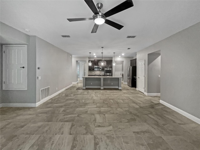 unfurnished living room with ceiling fan