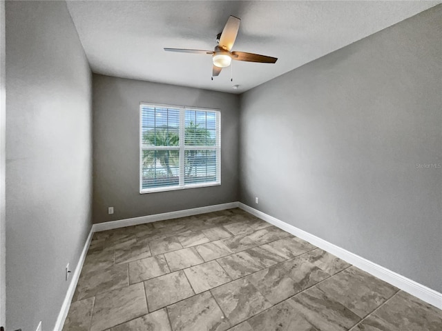 empty room with a textured ceiling and ceiling fan