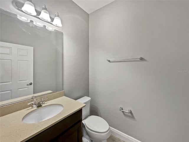 bathroom featuring toilet and vanity