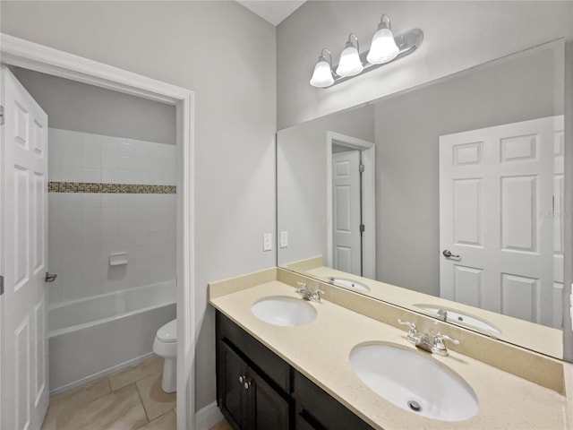 full bathroom featuring tiled shower / bath combo, vanity, toilet, and tile patterned floors