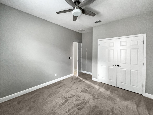 unfurnished bedroom featuring carpet flooring, a closet, and ceiling fan