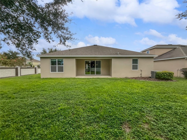 rear view of property featuring a yard