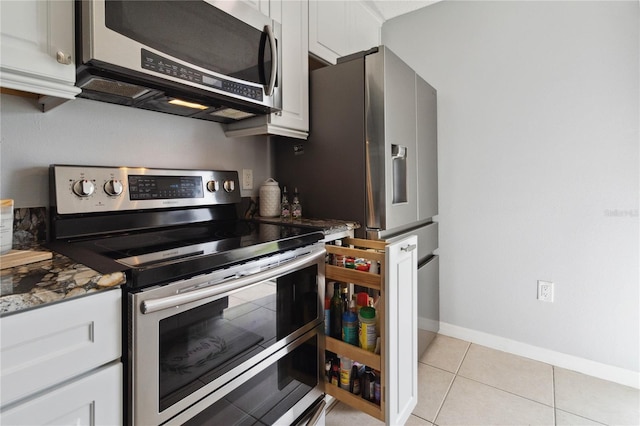 kitchen with light tile patterned floors, white cabinets, and appliances with stainless steel finishes