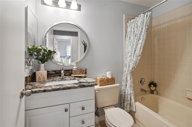 full bathroom with vanity, shower / tub combo with curtain, and toilet