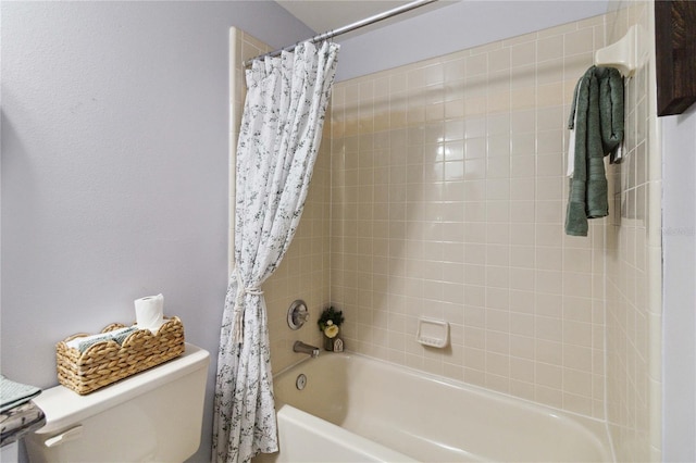 bathroom featuring shower / tub combo and toilet