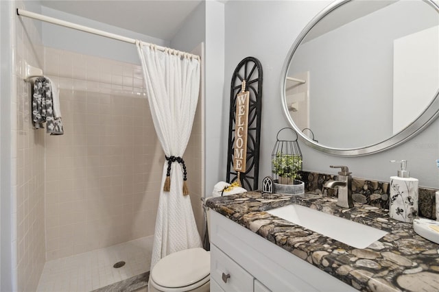 bathroom with vanity, toilet, and walk in shower