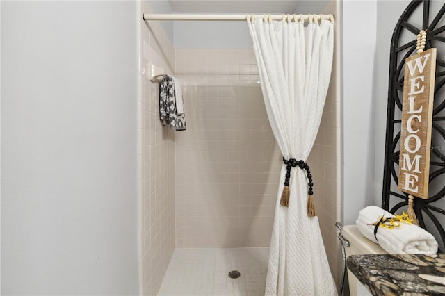 bathroom featuring curtained shower and toilet