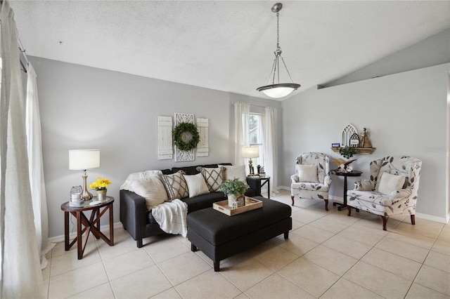 living room featuring lofted ceiling, light tile patterned floors, and a textured ceiling