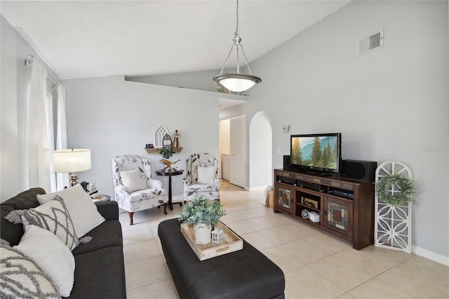 living room with lofted ceiling and light tile patterned floors