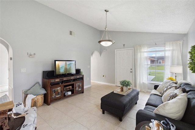 living room featuring high vaulted ceiling, a textured ceiling, and light tile patterned flooring