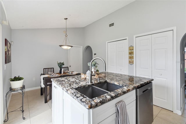 kitchen featuring sink, dishwasher, an island with sink, white cabinets, and light tile patterned flooring