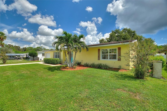 ranch-style house featuring a front lawn