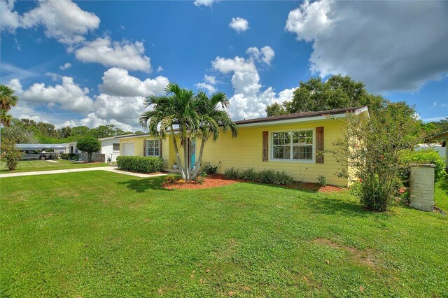 ranch-style house with concrete driveway, a front yard, and a garage