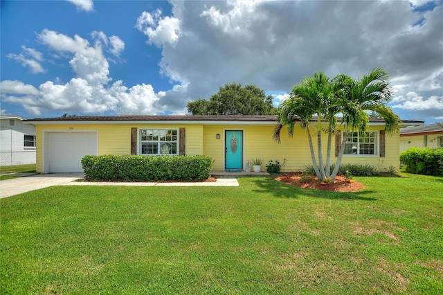 ranch-style house featuring an attached garage, driveway, and a front yard