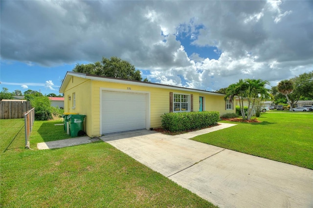 ranch-style house featuring fence, an attached garage, driveway, and a front lawn