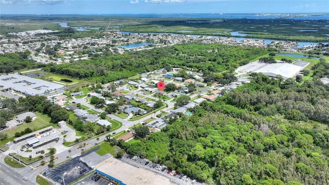 aerial view featuring a water view, a residential view, and a wooded view