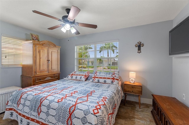 bedroom featuring baseboards and ceiling fan