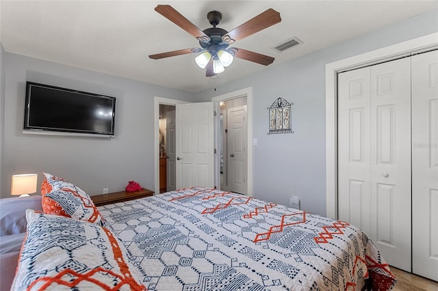 bedroom featuring a ceiling fan, visible vents, and a closet
