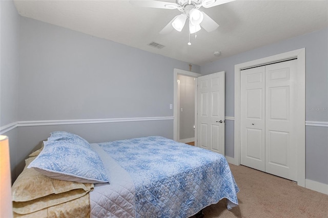 carpeted bedroom featuring baseboards, ceiling fan, a closet, and visible vents