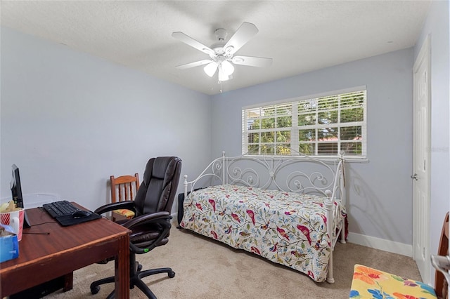 bedroom with a ceiling fan, baseboards, and carpet