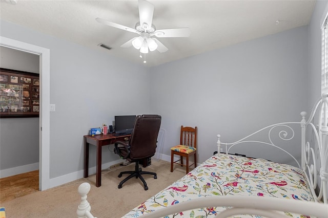 carpeted bedroom featuring baseboards, ceiling fan, and visible vents