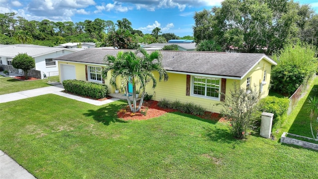 ranch-style house featuring concrete driveway, a shingled roof, a front lawn, and a garage