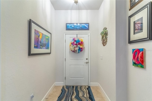 doorway to outside with tile patterned flooring