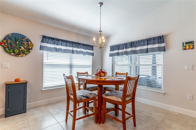 tiled dining space with a notable chandelier and vaulted ceiling