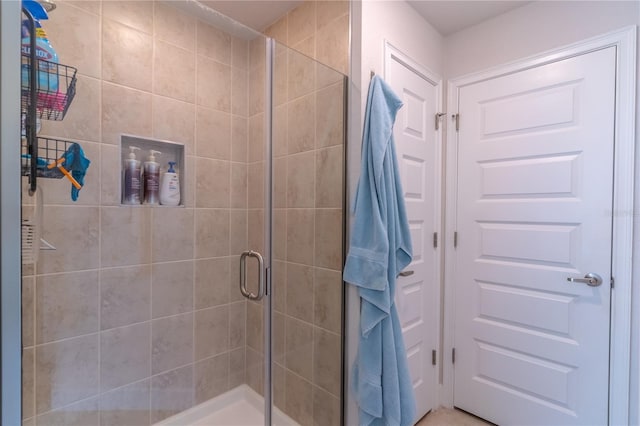 bathroom featuring a shower with door