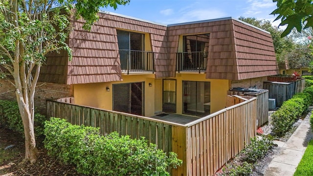 rear view of property featuring a balcony