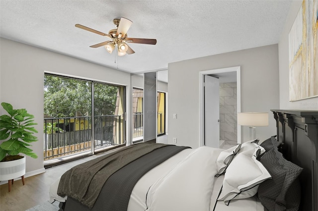 bedroom with wood-type flooring, a textured ceiling, access to exterior, ensuite bath, and ceiling fan