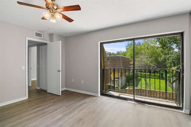 spare room with a textured ceiling, ceiling fan, and hardwood / wood-style flooring