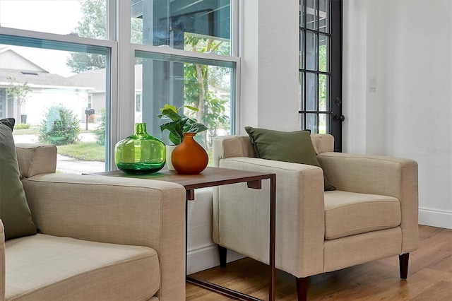 sitting room with wood-type flooring