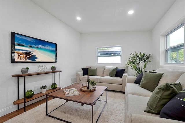 living room featuring vaulted ceiling and light hardwood / wood-style floors