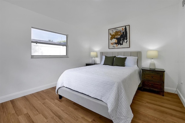 bedroom with hardwood / wood-style flooring